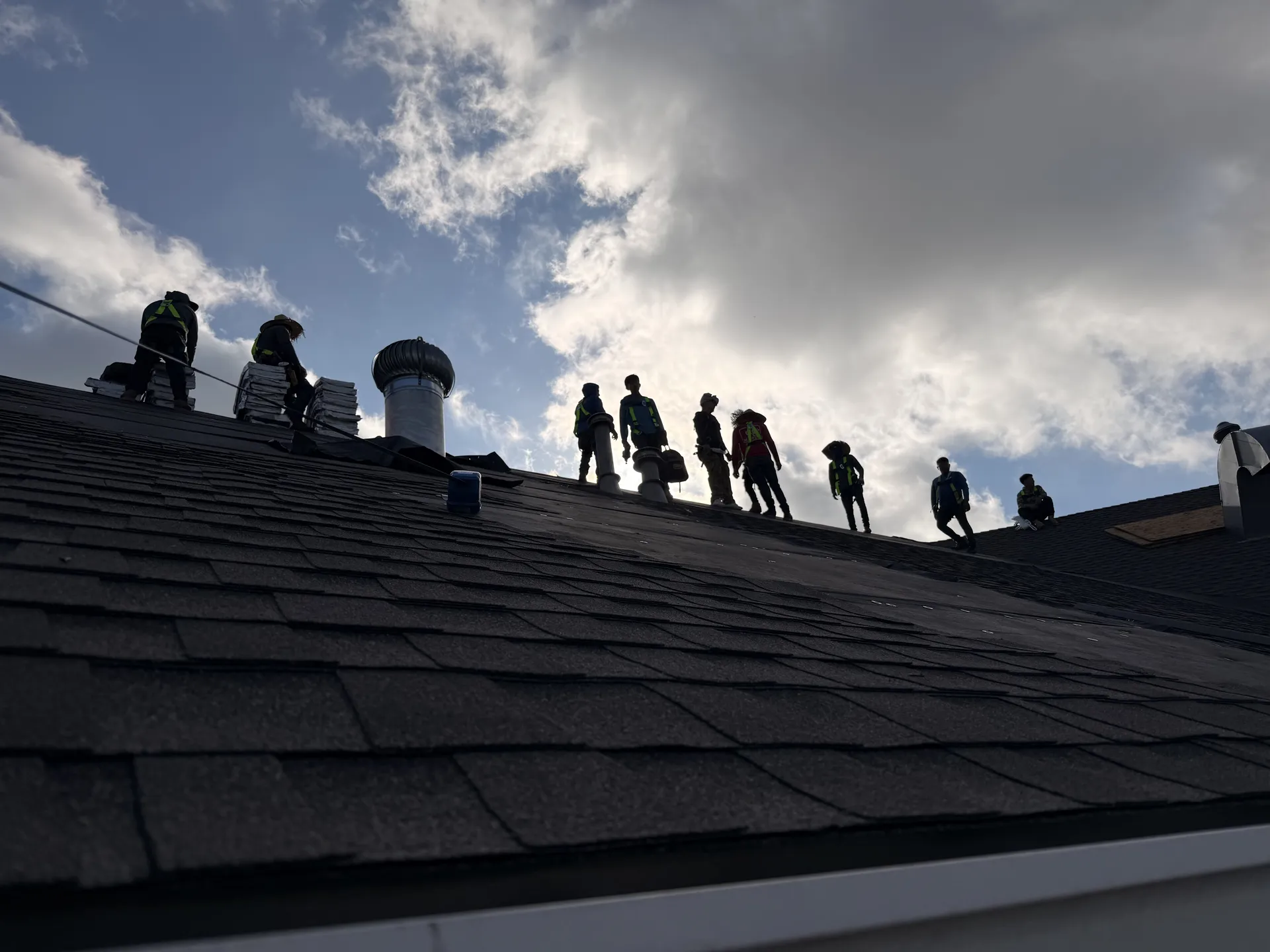 Elevated view of a chimney chase rebuild wrapped in insulation board with scaffolding in place