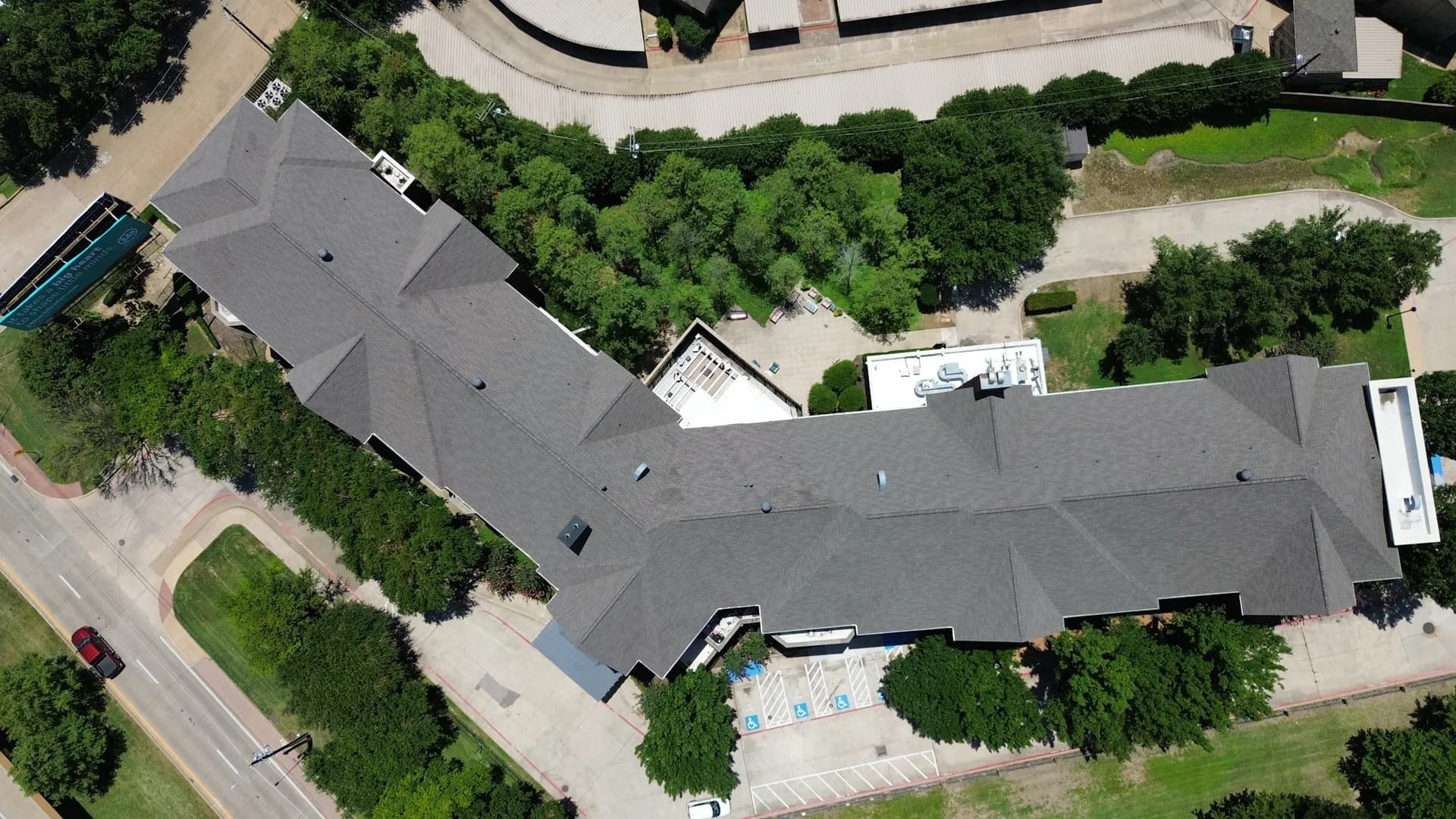 Aerial drone photo of a completed low-slope commercial roof on a long institutional building, representative of the large flat membrane spans used on data center roof construction projects.