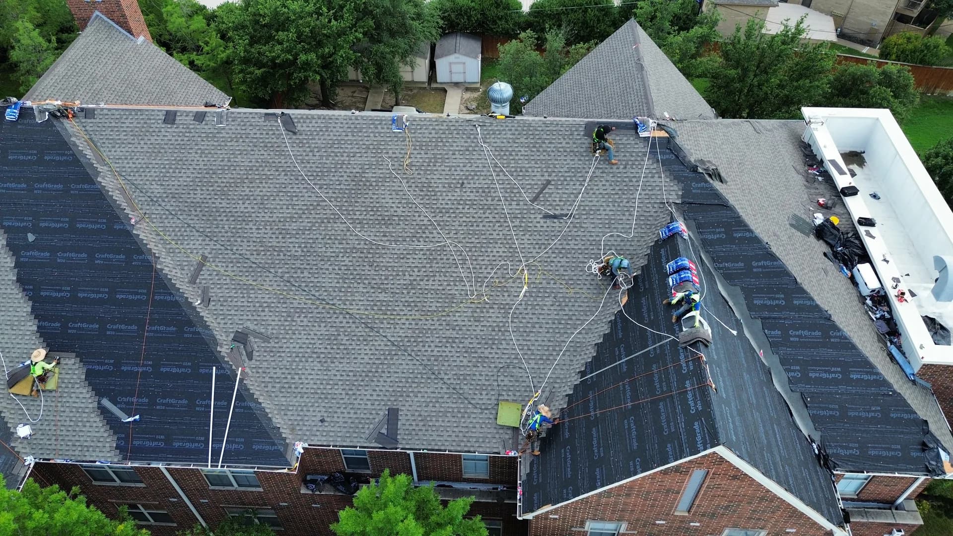 Aerial view of a newly replaced flat commercial roof with a fresh white membrane surface on a senior living facility