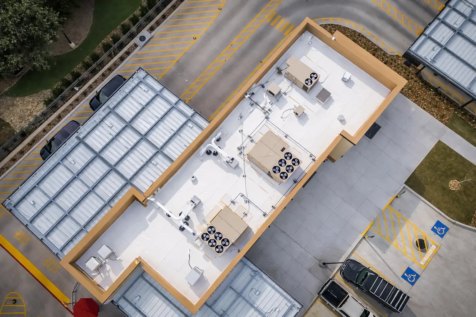 Aerial view of a white PVC roofing membrane installed on a quick-service restaurant building
