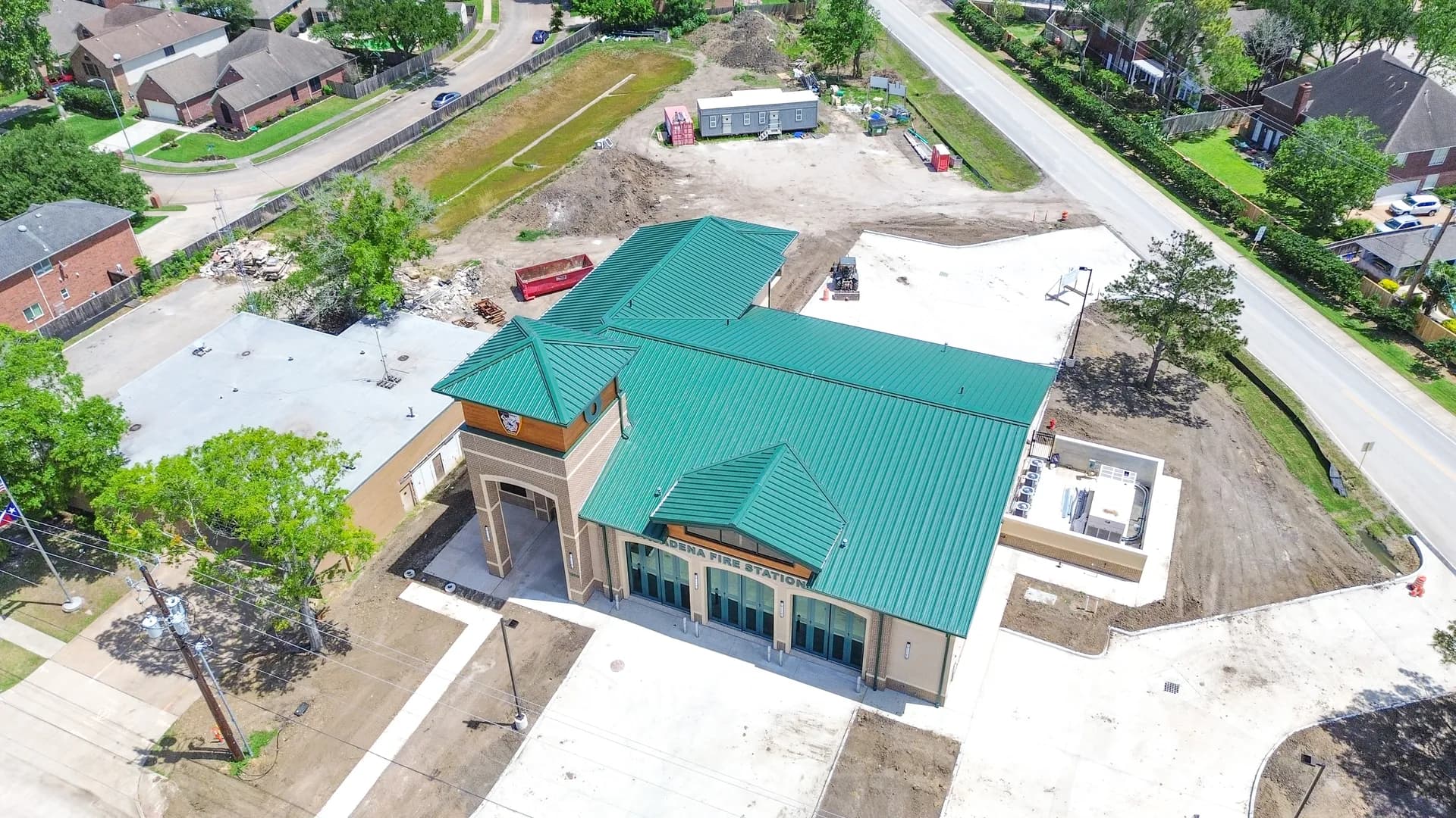 Aerial view of a white membrane roof on a commercial building where a leak would be traced across seams and penetrations