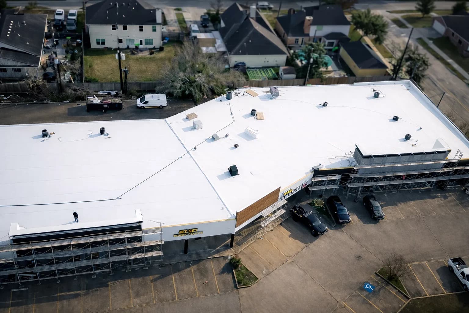 Aerial view of a white TPO membrane roof installed on a commercial building near The Woodlands, TX