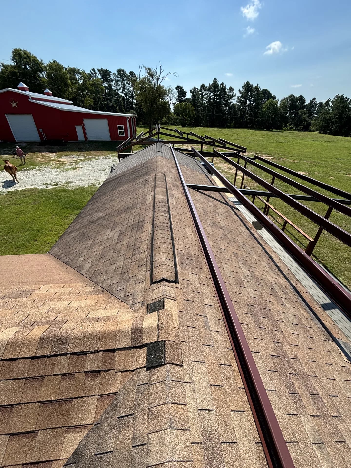 Roofers working along a roof plane where penetrations and flashing details are installed and sealed