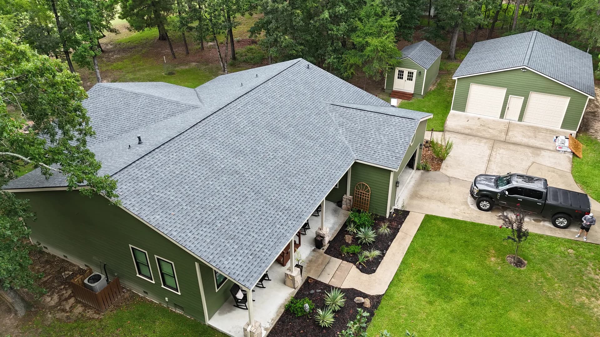 Aerial view of a residential property with a shingle roof