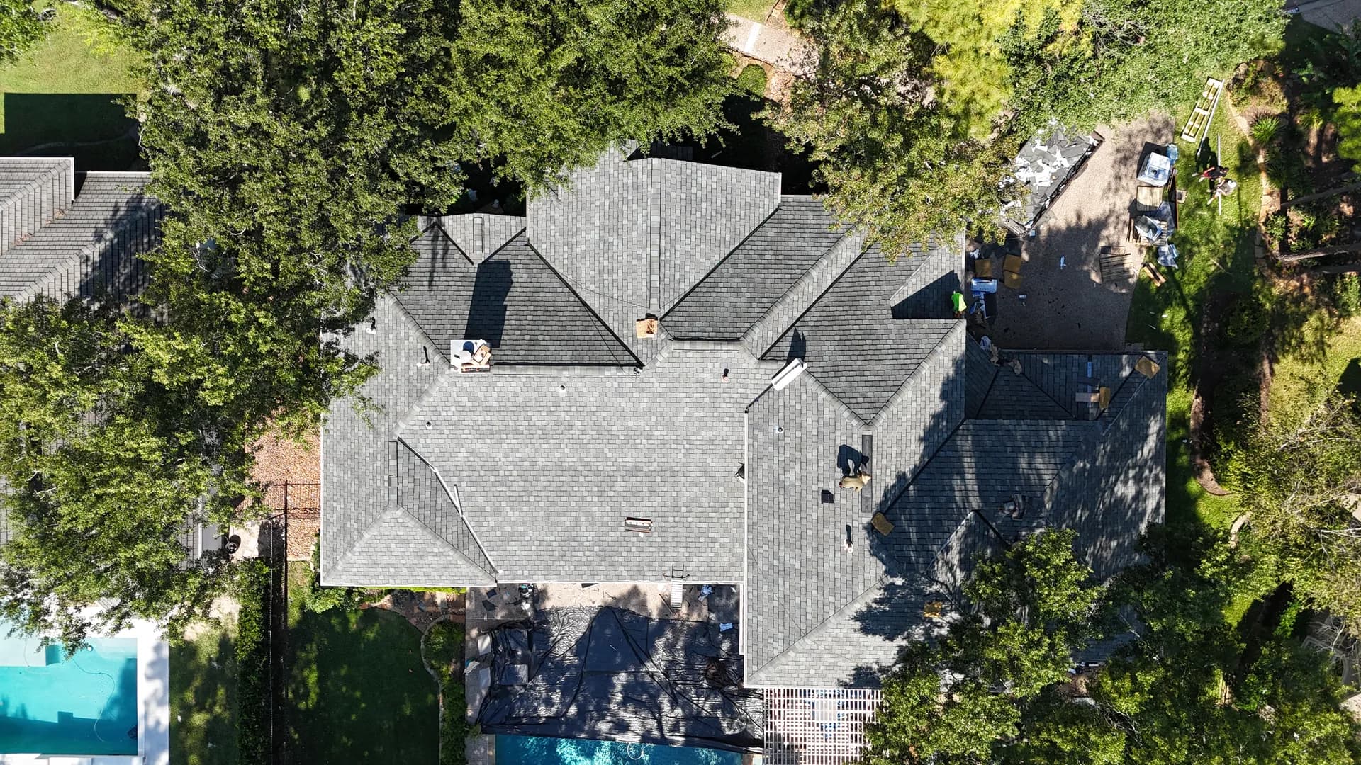 Close-up of a newly installed gray dimensional asphalt shingle roof by ROYH Build Co, showing shingle texture and color blend